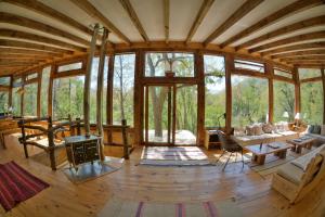 an open living room with a fireplace in a tree house at Onai Hostel in Las Trancas