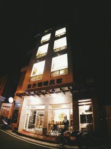 a tall building with lit windows at night at G.S Cafe in Magong