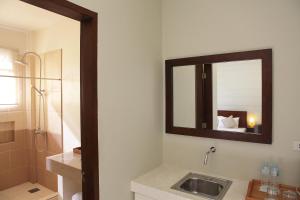 a bathroom with a sink and a mirror at Alba Uno Hotel in Cebu City
