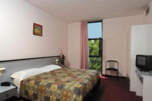 a hotel room with a bed and a window at Hotel Giannina in Forlimpopoli