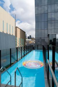 a swimming pool on the roof of a building at Adelphi Hotel in Melbourne