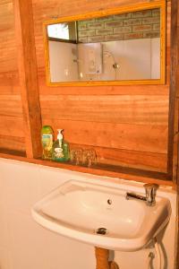 a bathroom with a sink and a mirror at Kipling's Bay Guest house in Ngapali