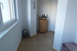 an empty hallway with a table and a window at Appartement July in Innsbruck +17 photos