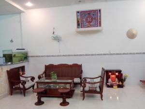 a living room with two chairs and a table at The House 17/1 in Mui Ne