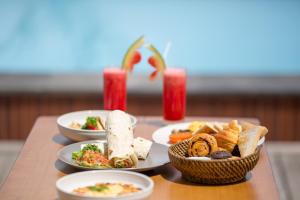 a table with three plates of food on it at Semabu Hills Hotel Nusa Penida in Nusa Penida