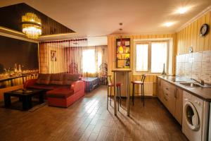 a living room with a couch and a kitchen at ApartLux Chernigov in Chernihiv