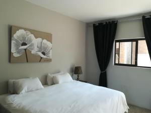 a bedroom with a white bed and a window at Willow Banks Lodge in Parys +65 photos
