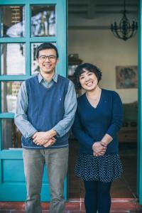 a man and a woman standing in front of a blue door at Sunday Home in Dayin