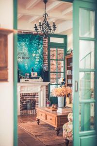 a living room with a fireplace and a table at Sunday Home in Dayin