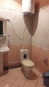 a bathroom with a toilet and a sink at Hotel Sultanmurat in Almetyevsk