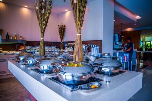 a buffet line with many pots and pans of food at Novotel Yanbu Albahr in Yanbu