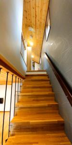 a staircase in a building with wooden floors and wooden ceilings at Kitsune Cottages in Hakuba