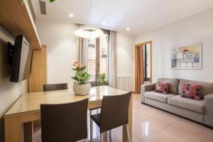 a living room with a dining table and a couch at Bcngotic in Barcelona