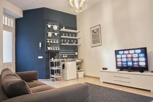 a living room with a couch and a television at ONYX Apartment in Budapest