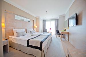 A bed or beds in a room at Ramada Resort by Wyndham Bodrum