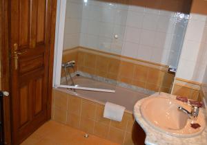 a bathroom with a sink and a bath tub at Posada El Valle - Adults Only in Suances