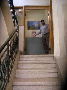 アンマンにあるマンスール ホテルの階段の出入口に立つ男