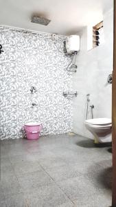 a bathroom with a sink and a toilet in a room at Sealand Beach Cottages in Patnem +36 photos