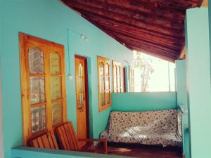 a room with a bench and some windows at Sealand Beach Cottages in Patnem