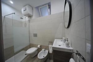 a bathroom with a sink and a toilet and a mirror at Borgo Martino in Bari