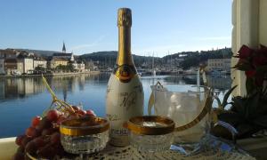 a bottle of wine sitting on a table with glasses at Holiday home Gariful in Milna