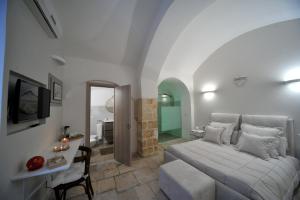 a bedroom with a bed and a table and a chair at Borgo Martino in Bari