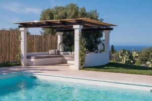 a pergola next to a swimming pool at Villa del Vento in Polignano a Mare