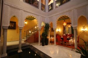 a lobby with a swimming pool in a building at Riad Moullaoud in Marrakesh