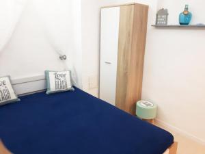 a bedroom with a blue bed and a door at Ferienwohnung Talblick in Eisenach