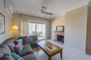 a living room with a couch and a fireplace at Cubo's Apartamento Tarajes La Cala in La Cala de Mijas