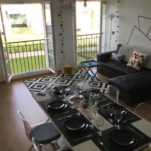 a dining room with a table with wine glasses on it at SouheilRebekaHome in Serris