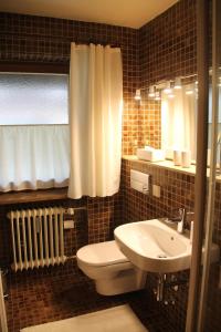 a bathroom with a white toilet and a sink at Ferienwohnung "Unterberg" in Reit im Winkl
