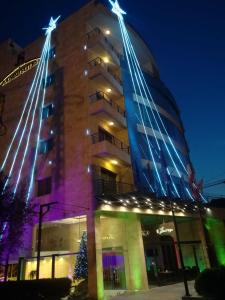 a building with a christmas tree in front of it at Jounieh Suites Boutique Hotel in Jounieh