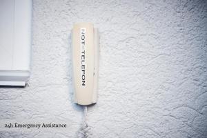 a white wii remote on a white wall at Private Holiday Homes by Solaria in Davos +19 photos
