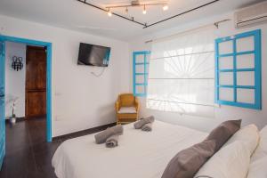 a bedroom with a large white bed with blue accents at Palm Villa in Puerto del Carmen