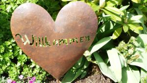 a heart with the word wilderness written on it at Ferienwohnung chez nous in Erbach im Odenwald