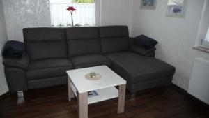 a living room with a couch and a table at Ferienwohnung chez nous in Erbach im Odenwald