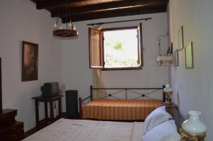 a bedroom with a bed and a window at Epavlis Iosif in Hora Sfakion