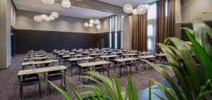 a conference room with tables and chairs and plants at Thon Partner Hotel Horten in Horten