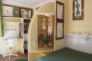two pictures of a room with a bed and a mirror at Country House Il Covo della Civetta in Barberino di Val dʼElsa