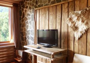 a television sitting on a wooden table in a room at Villa Mark in Kraevo