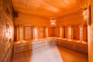 an empty room with wooden walls and windows at Apartamenty Sun & Snow Nowa Motława in Gdańsk