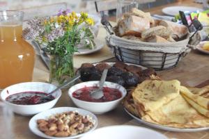 a table with a bunch of different types of food at Chambres Aux Bonnes Herbes in Bais
