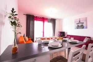 a dining room and living room with a table and chairs at Paleochora Apartments in Palaiochóra