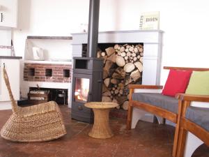 a living room with a wood stove and a couch at La Tourelle in Saint-Agnan-sur-Sarthe