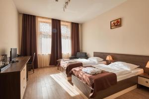 Voodi või voodid majutusasutuse Hotel Gino Wellness Rabath toas