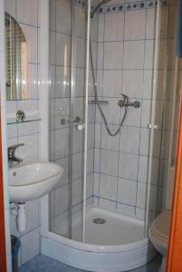 a bathroom with a shower and a sink and a toilet at Hotel Anka in Słubice