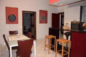 a kitchen with a table and chairs and a counter top at Diana e Atteone in Caserta