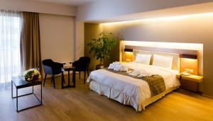 A bed or beds in a room at Philippos Xenia Hotel