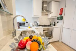 a kitchen with a bowl of fruit on a counter at Urban Chic - Basing Street in London